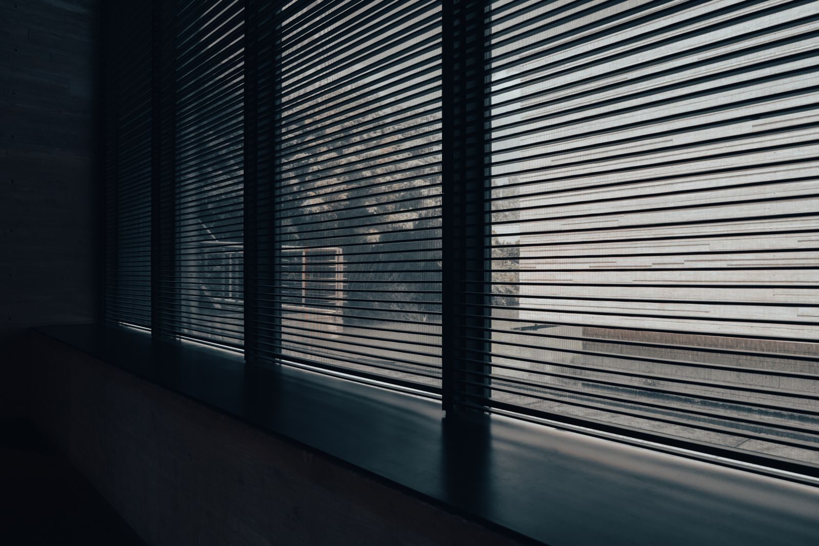 Modern interior space with sleek blinds providing a minimalist aesthetic and diffused natural light.