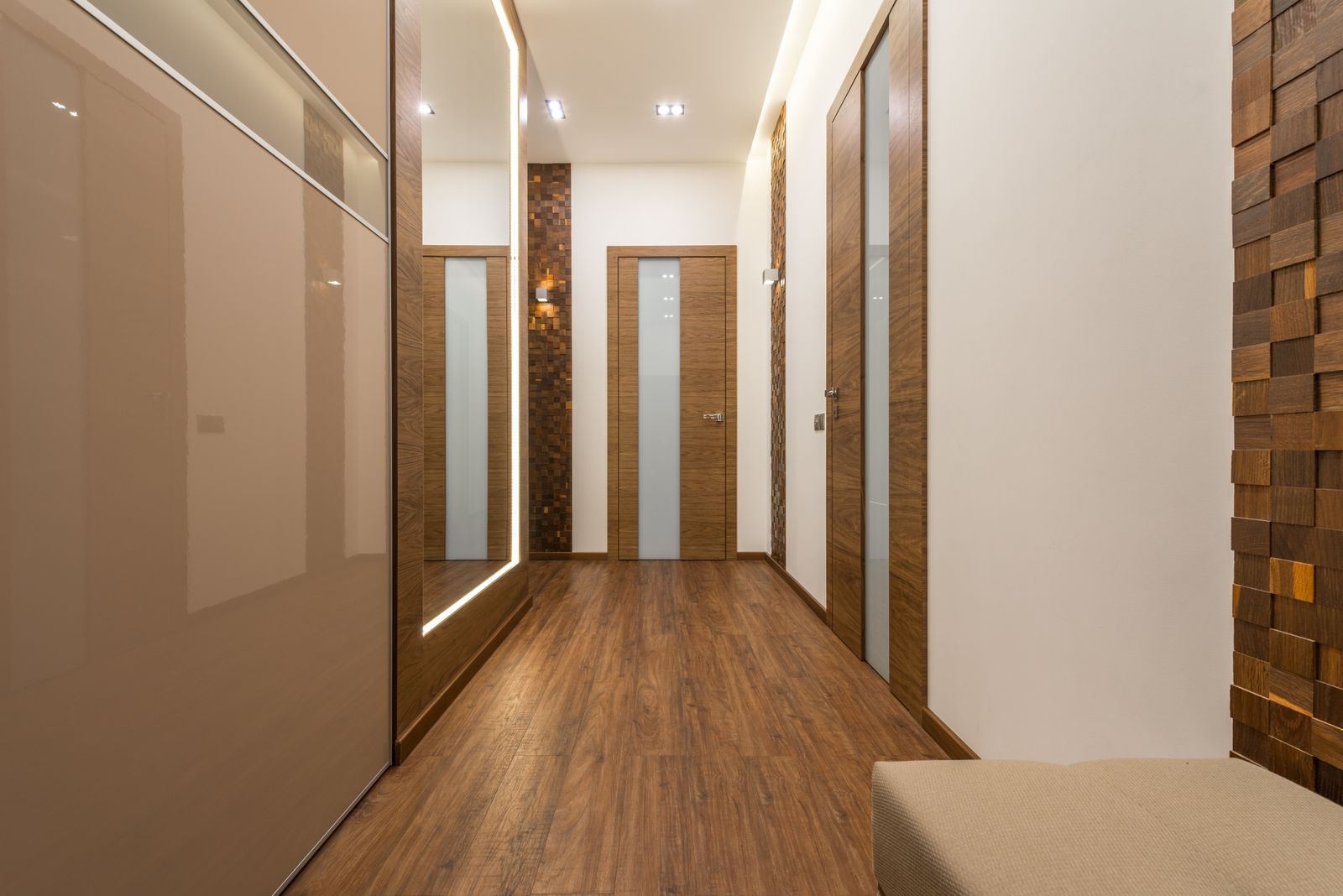 Sleek and luxurious hallway featuring wooden elements, elegant lighting, and modern design.